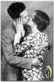 In television the radio love-scene must necessarily look like the real thing. Kisses have to be planted where they belong, instead of on the back cf the hand held before the microphone — so Ann Chase and Carleton Young of the NBC National Players in San Francisco, are doing a bit of rehearsing. Ann was among the leaders in the third annual search for the most beautiful radio artist in America, being conducted by the Radio-Electrical World's Fair in New York. She and Betty Kelly, also an aspirant for the microphone's crown of beauty represent Station KGO San Francisco and Oakland, key-station of the National Broadcasting Company's Pacific network. (Readers Digest, Oct 1931)