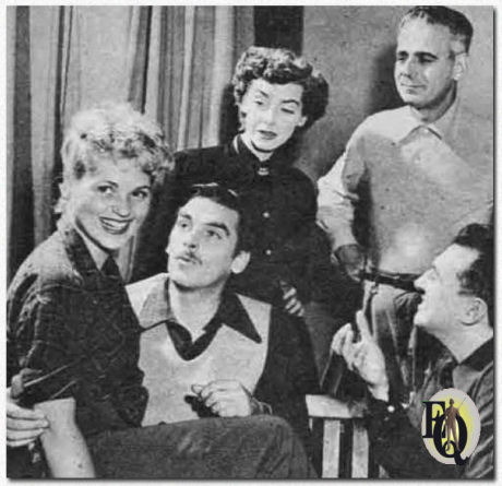  For the "Ford Theatre" episode "She Loves Me Not" (1949) director Marc Daniels (R) instructs (L to R) Judy Holliday, Richard Hart, Marsha Hunt, Paul Stewart.